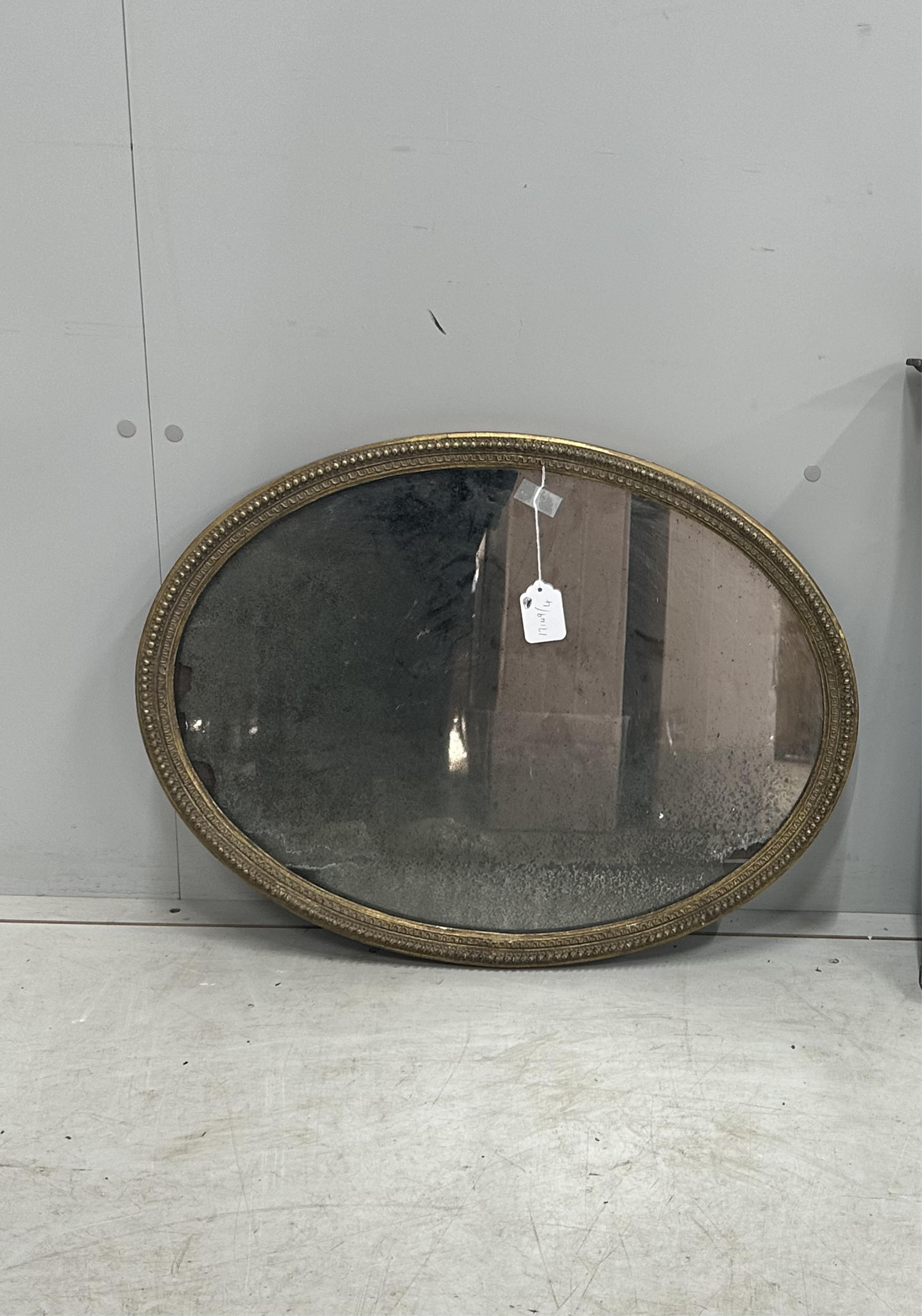 A 19th century oval giltwood wall mirror, width 65cm, height 49cm. Condition - fair